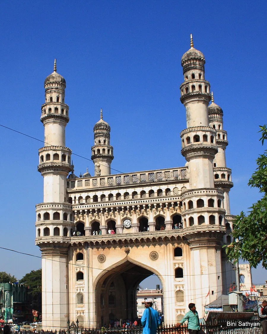 Full view of Charminar and its minarets under a blue sky in Hyderabad, Telangana